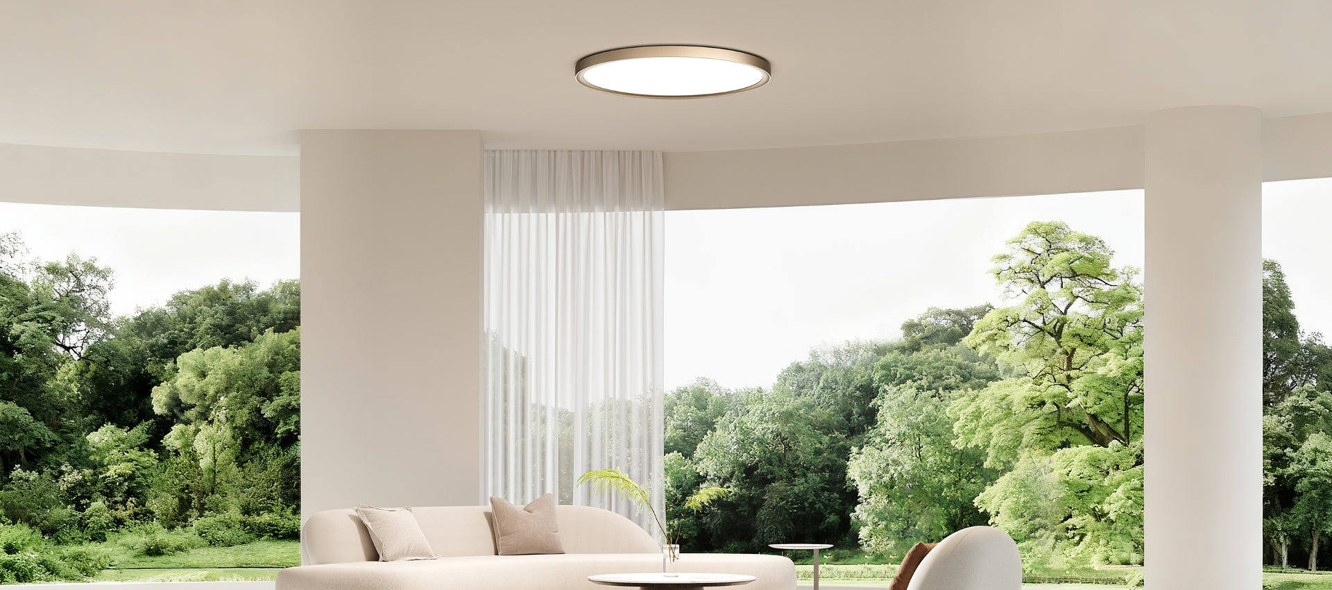 A lipro living-room scene with a ceiling light and large windows overlooking green trees